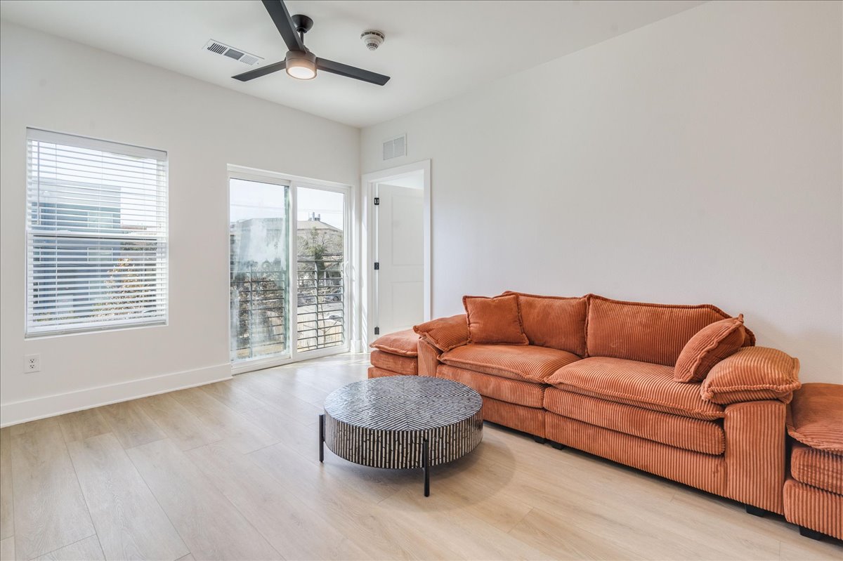 3000 Duval Street, Unit 102 Austin, TX 78705 - Photo 6 of 40 Living area featuring light wood finished floors and a ceiling fan
