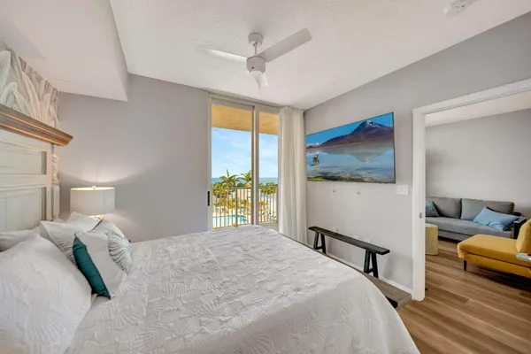 a view of a hallway with closet and wooden floor