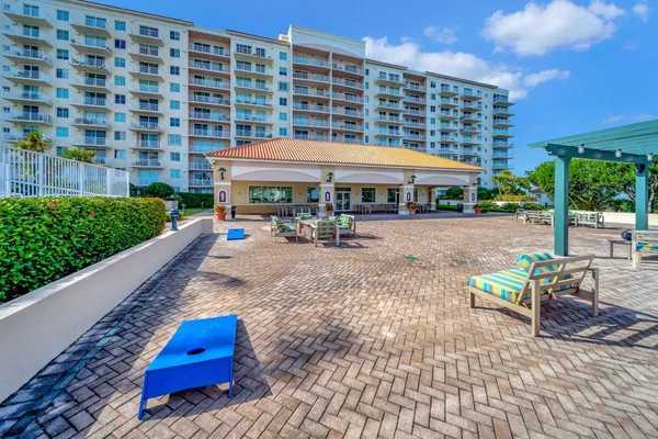 a swimming pool with outdoor seating and yard