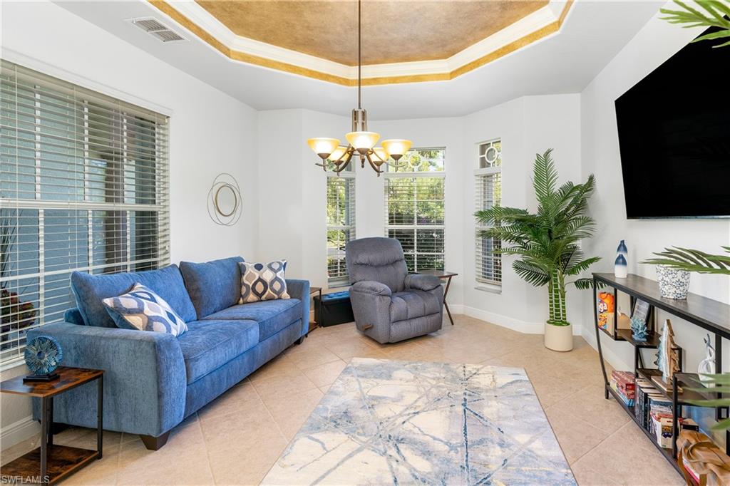 4923 Cerromar Drive Naples, FL 34112 - Photo 11 of 39 a living room with furniture and a flat screen tv