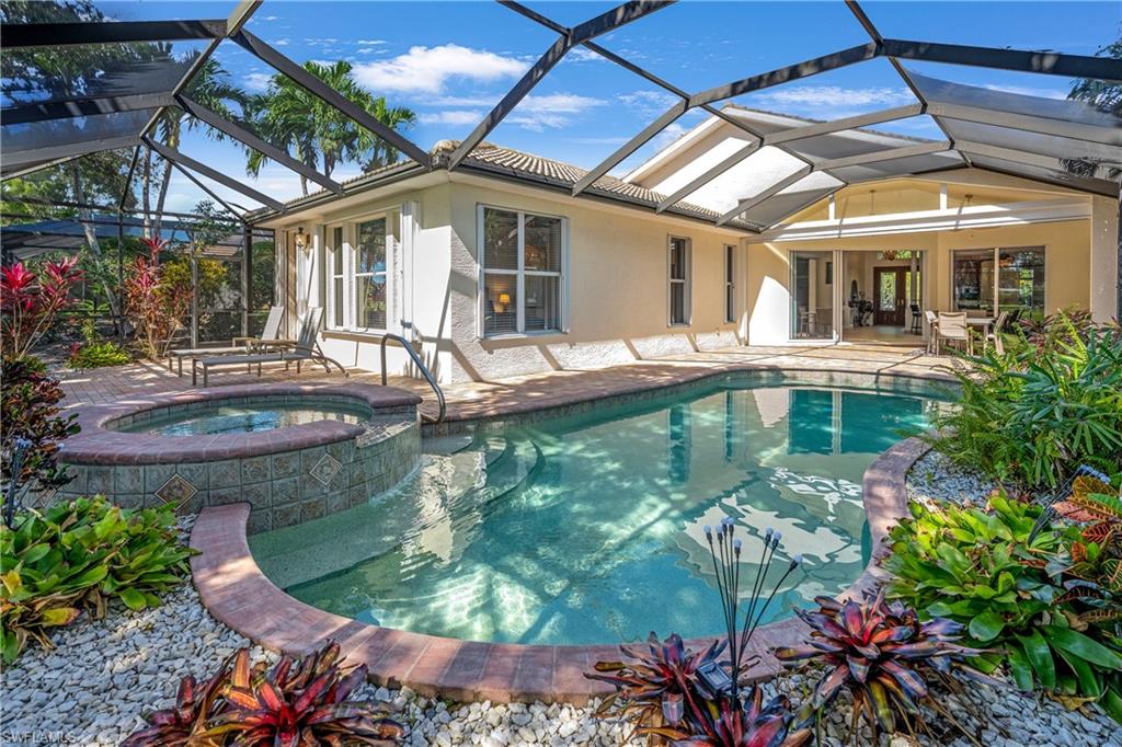 4923 Cerromar Drive Naples, FL 34112 - Photo 15 of 39 a front view of a house with swimming pool