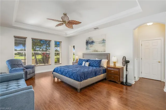 a spacious bedroom with a bed and a couch