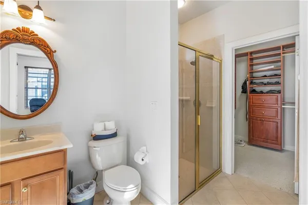 a bathroom with a toilet a sink and a mirror