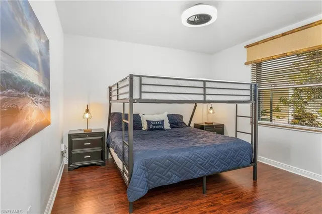 a bedroom with a bed and a mirror