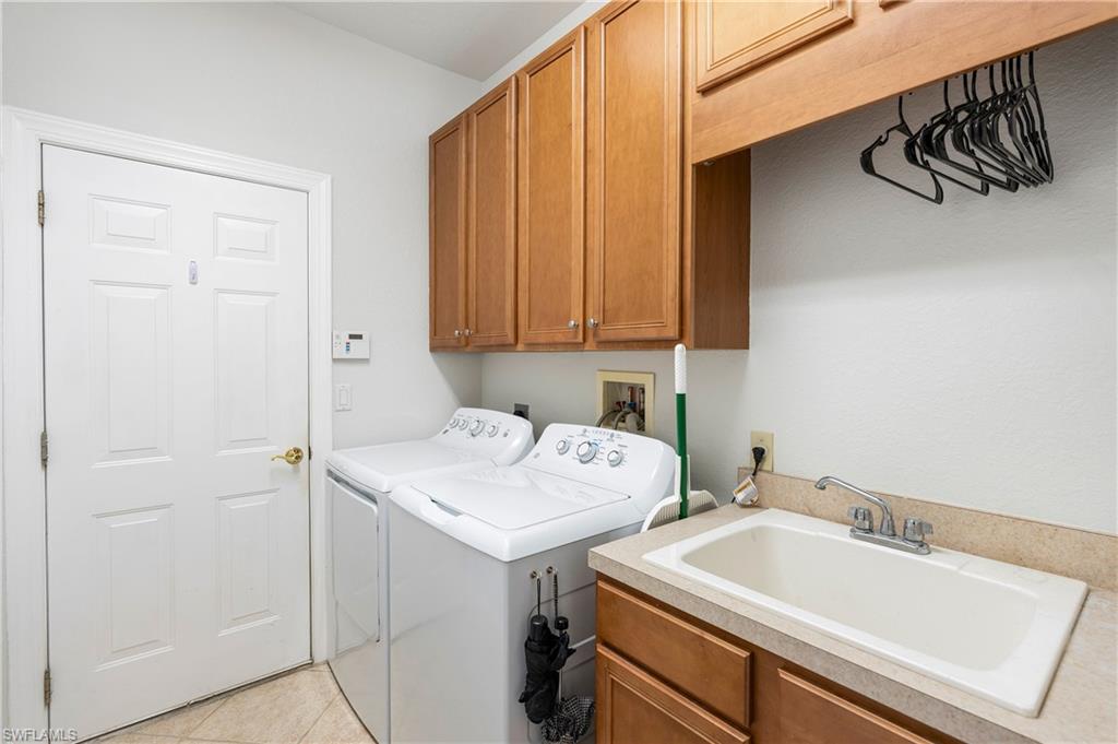 4923 Cerromar Drive Naples, FL 34112 - Photo 26 of 39 a utility room with dryer and washer