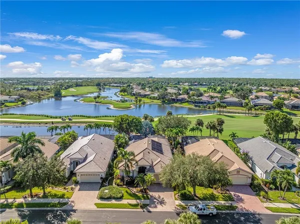 an aerial view of residential houses with outdoor space and ocean view