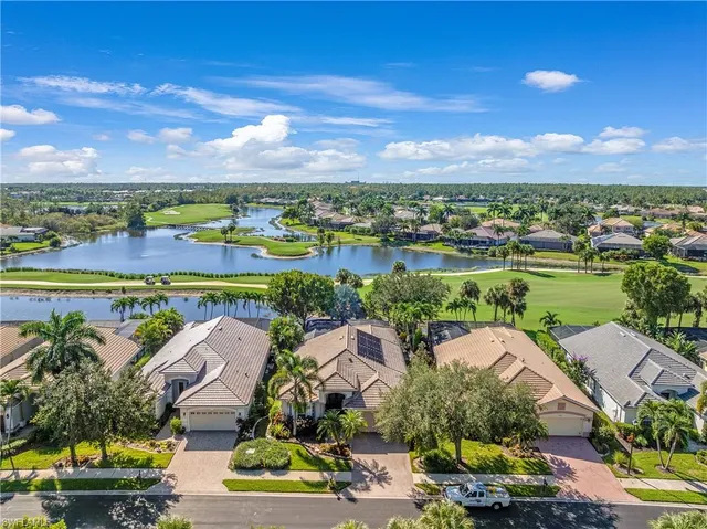 an aerial view of residential houses with outdoor space and ocean view