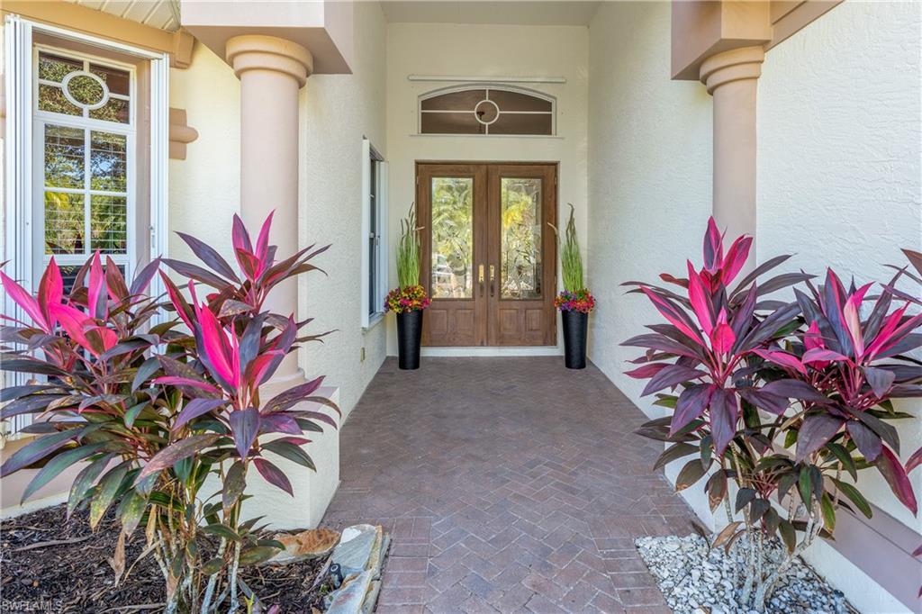 4923 Cerromar Drive Naples, FL 34112 - Photo 3 of 39 a potted plant sitting in front of a house