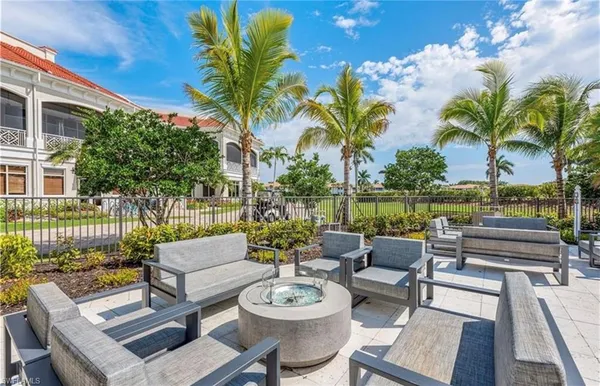 a view of a patio with couches potted plants and water view