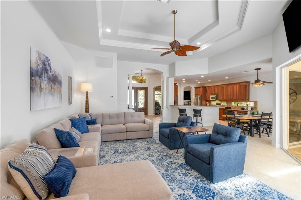 4923 Cerromar Drive Naples, FL 34112 - Photo 6 of 39 a living room with furniture kitchen view and a chandelier