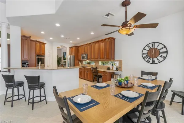 a kitchen with a dining table and chairs