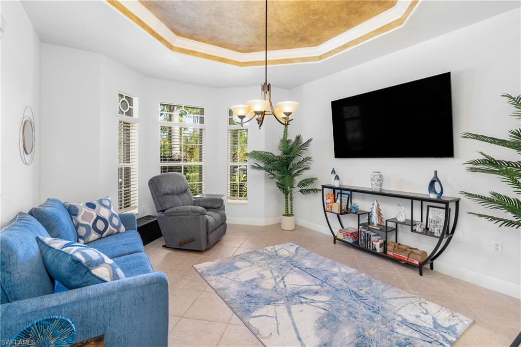 4923 Cerromar Drive Naples, FL 34112 - Photo 10 of 39 a living room with furniture and a flat screen tv