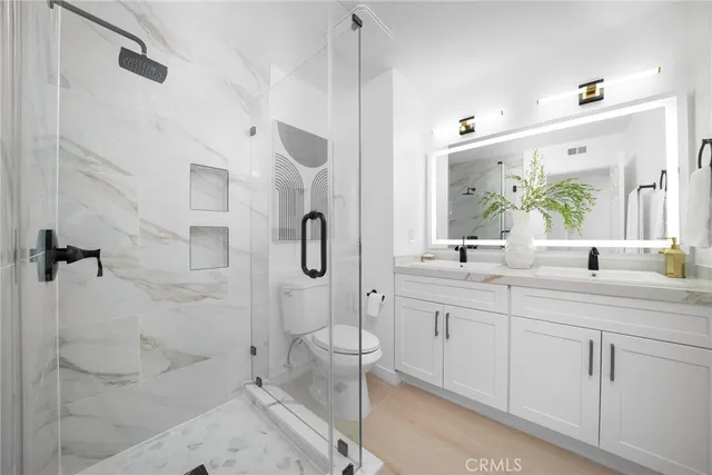a spacious bathroom with a shower sink and mirror
