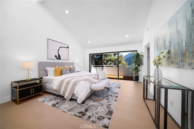 a bed room with a bed and a large window