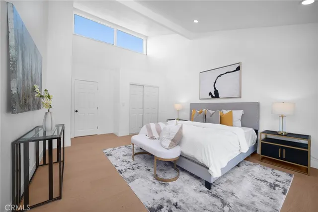 a bedroom with a bed and wooden floor