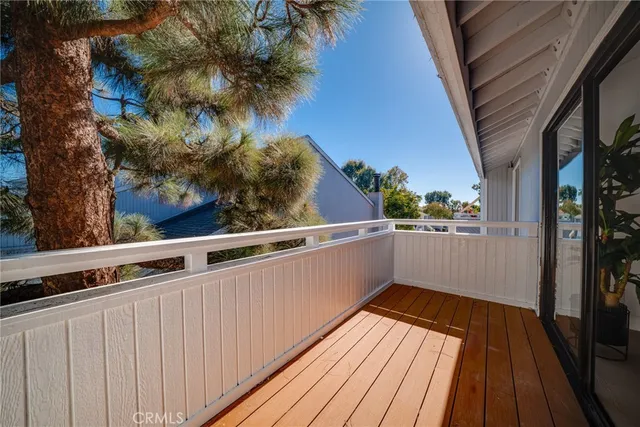 a view of balcony with wooden floor and fence