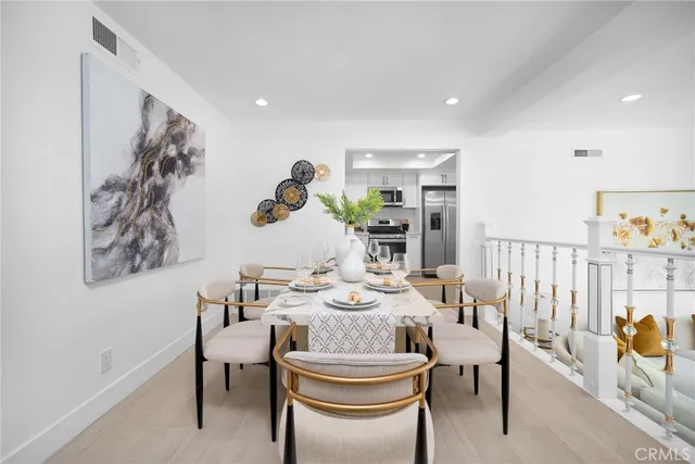 a dining room with furniture and wooden floor