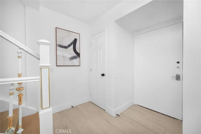 a view of an entryway with wooden floor