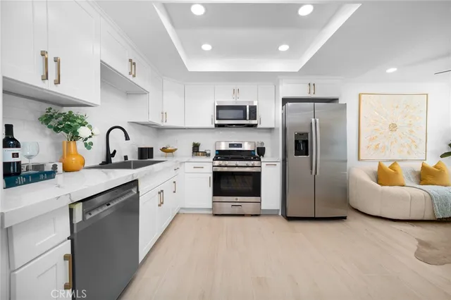 a kitchen with furniture a refrigerator and a sink