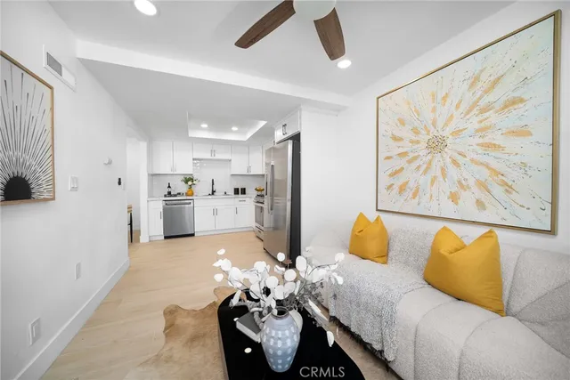 a living room with furniture and kitchen view