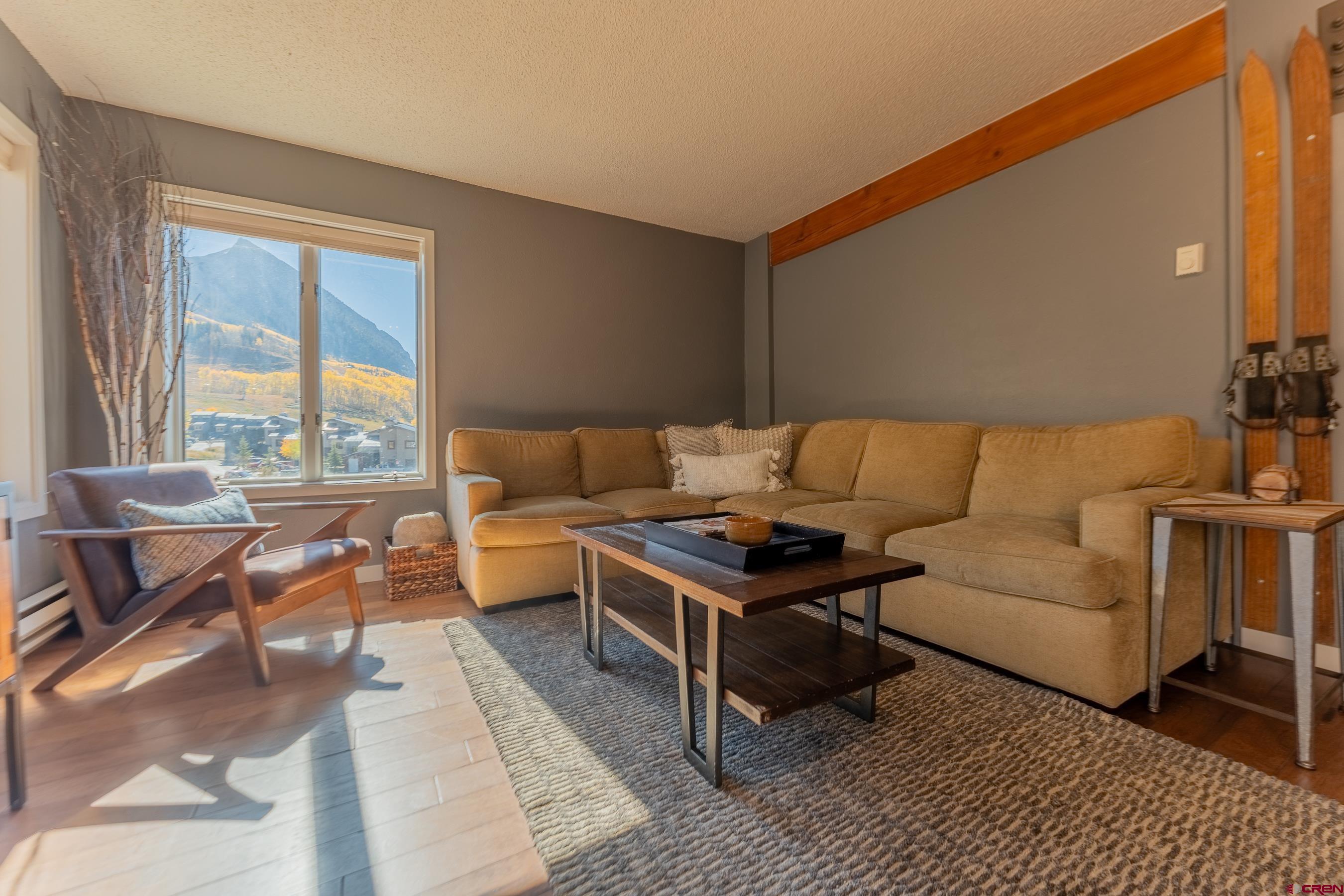 25 Emmons Road, Unit 37 Crested Butte, CO 81225 - Photo 12 of 35 a living room with furniture and a large window