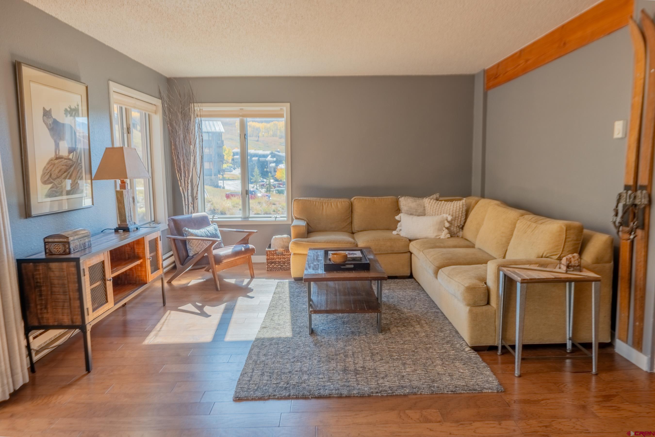 25 Emmons Road, Unit 37 Crested Butte, CO 81225 - Photo 13 of 35 a living room with furniture window and a table