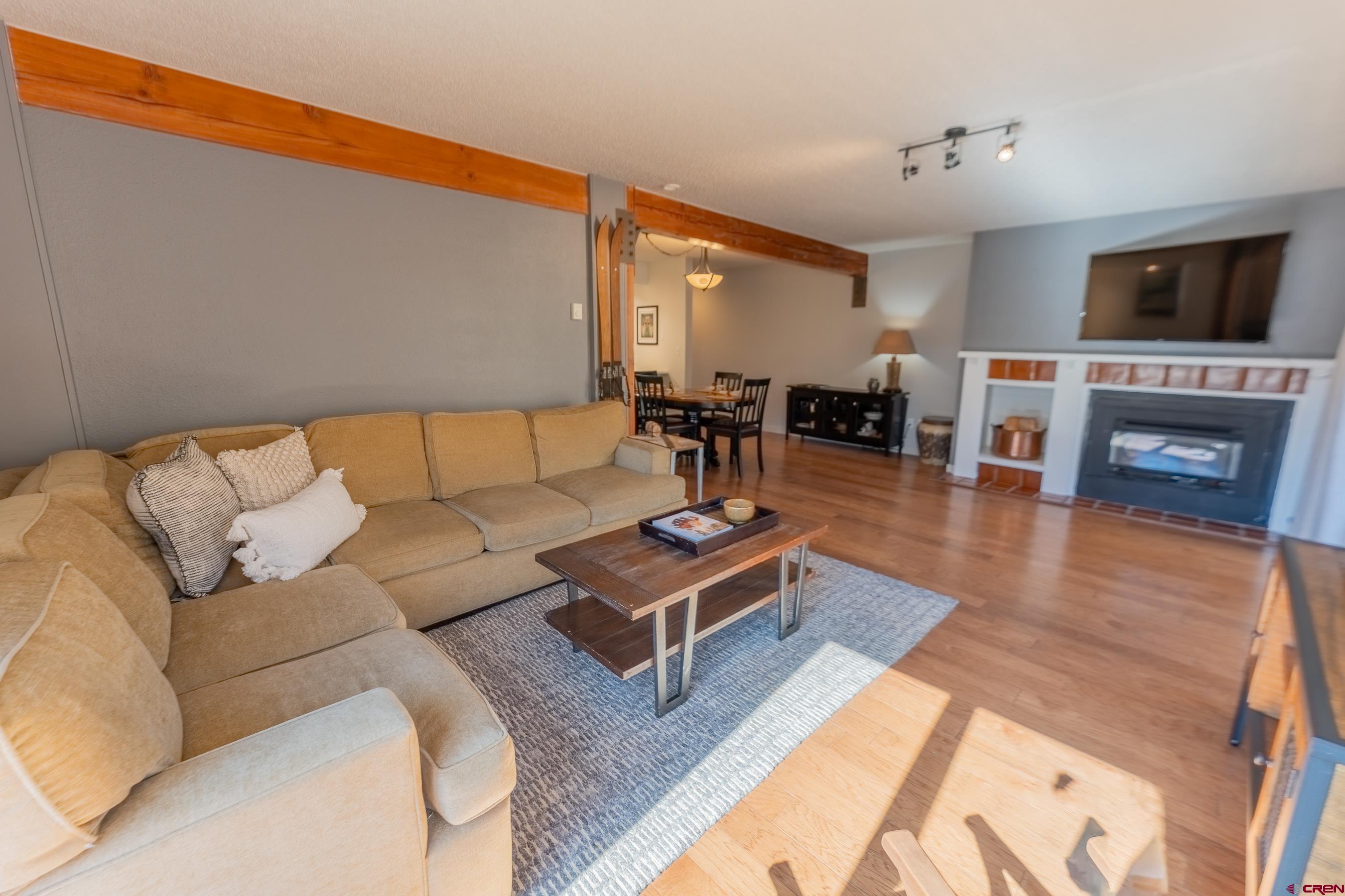 25 Emmons Road, Unit 37 Crested Butte, CO 81225 - Photo 15 of 35 a living room with furniture a flat screen tv and a fireplace