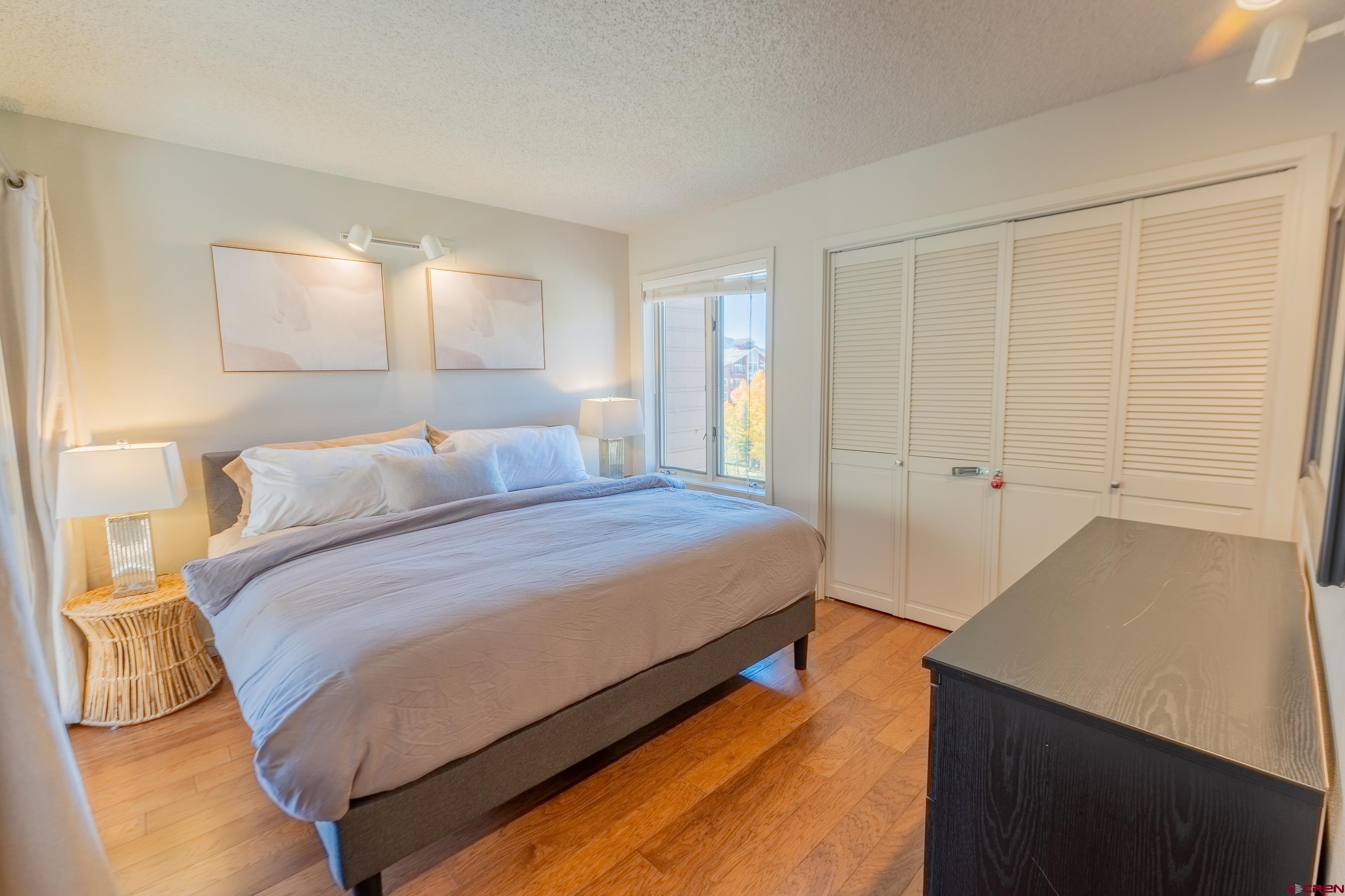 25 Emmons Road, Unit 37 Crested Butte, CO 81225 - Photo 17 of 35 a bedroom with a bed and a lamp