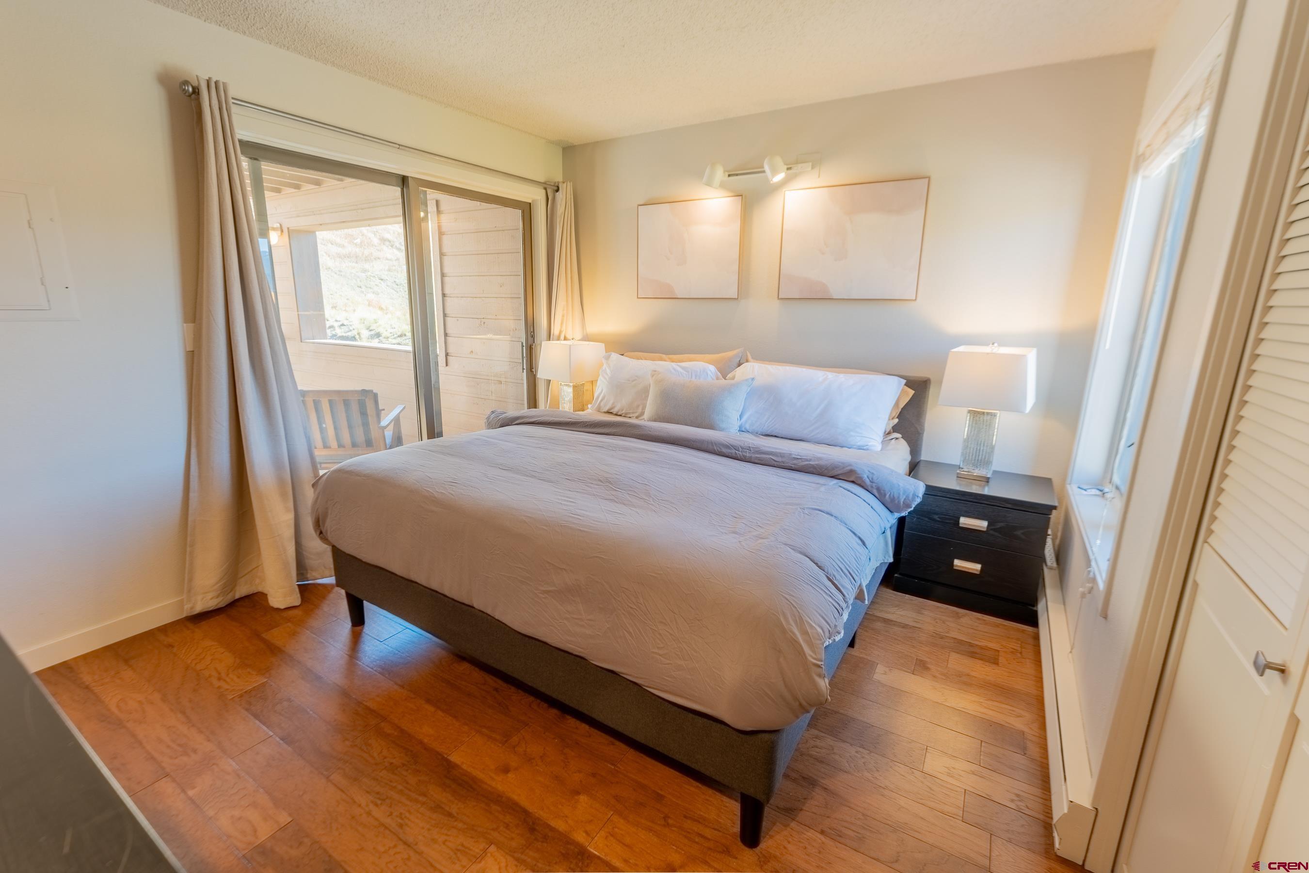 25 Emmons Road, Unit 37 Crested Butte, CO 81225 - Photo 18 of 35 a bedroom with a bed and wooden floor
