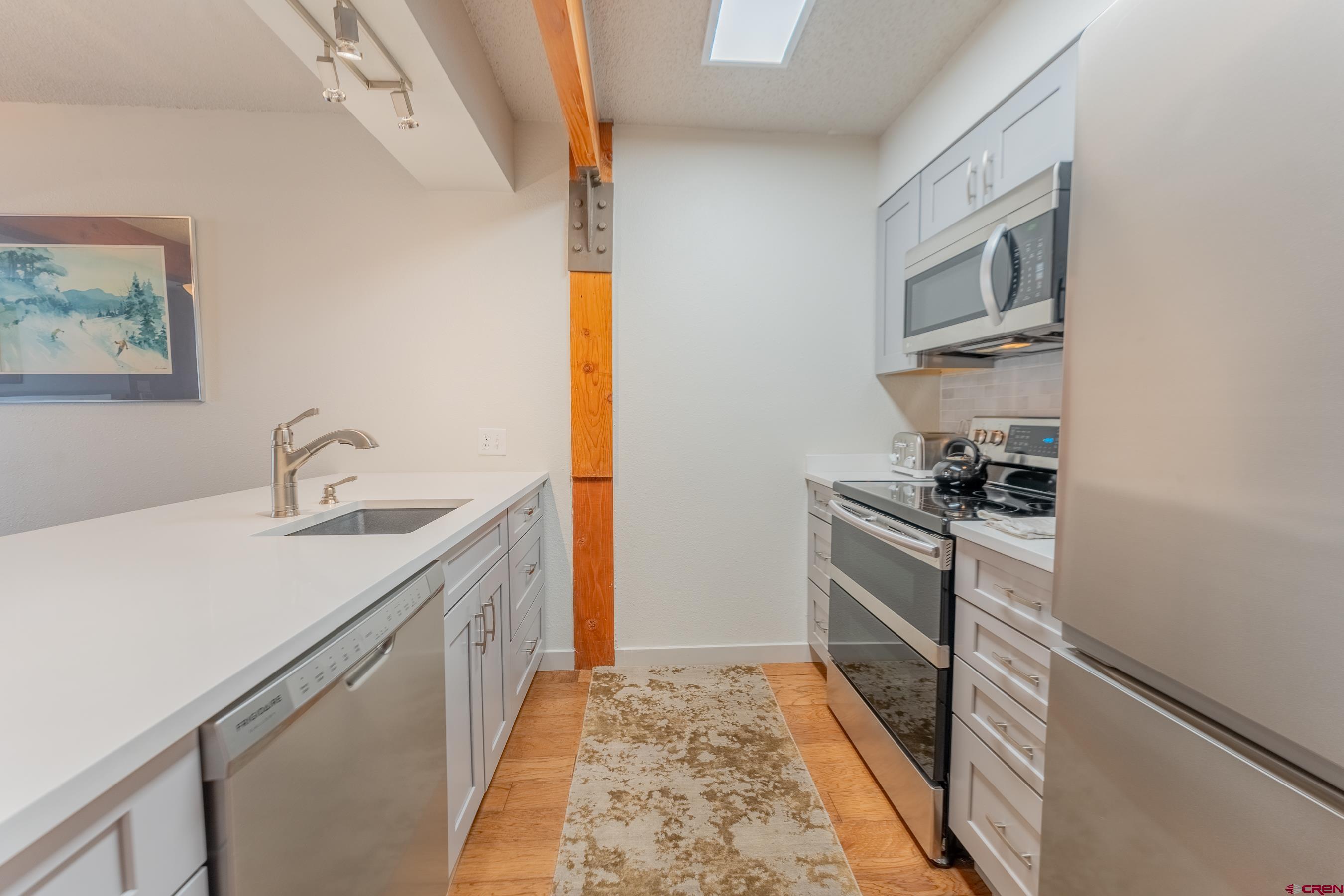 25 Emmons Road, Unit 37 Crested Butte, CO 81225 - Photo 6 of 35 a kitchen with stainless steel appliances a sink and a stove