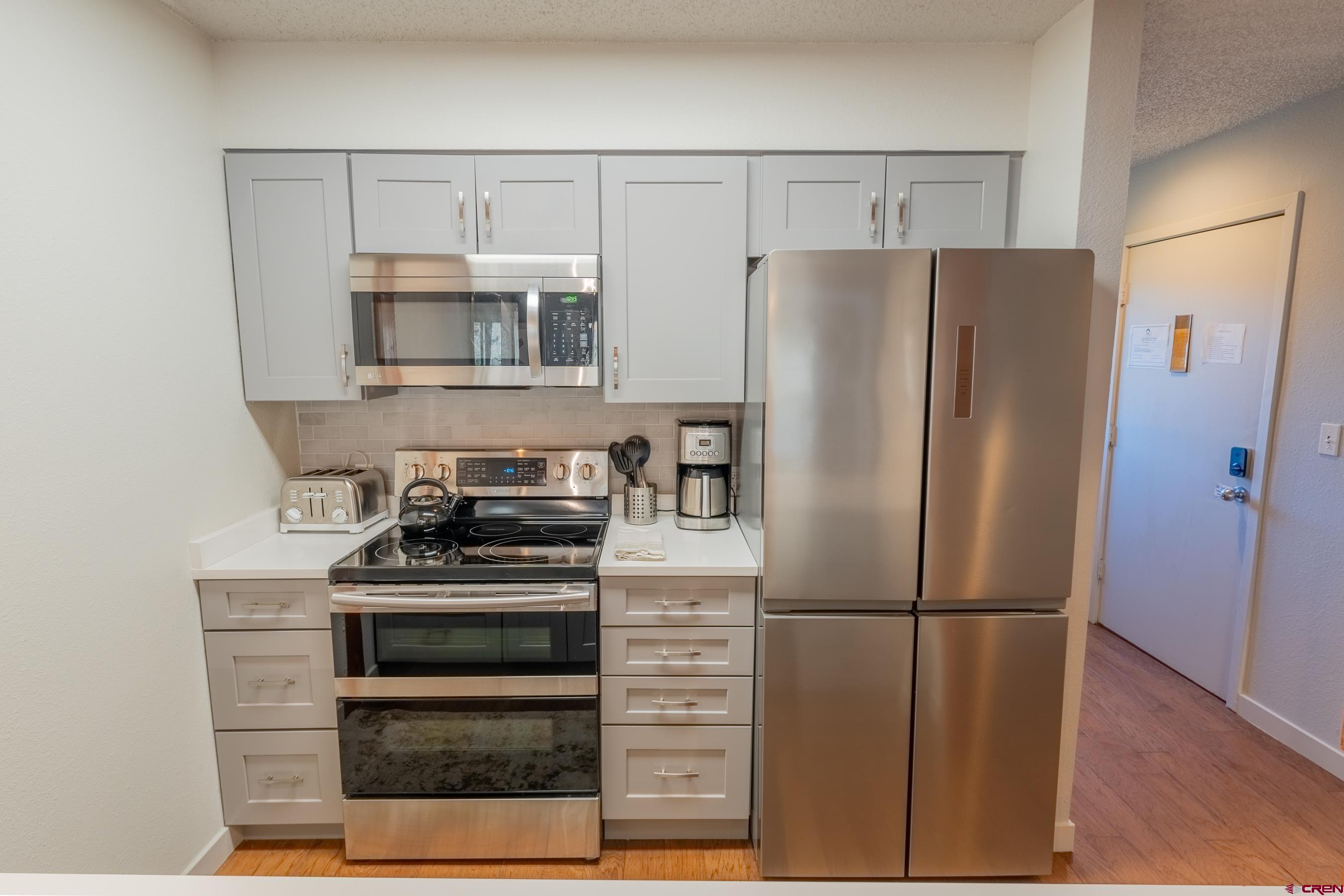 25 Emmons Road, Unit 37 Crested Butte, CO 81225 - Photo 7 of 35 a kitchen with a refrigerator stove and microwave