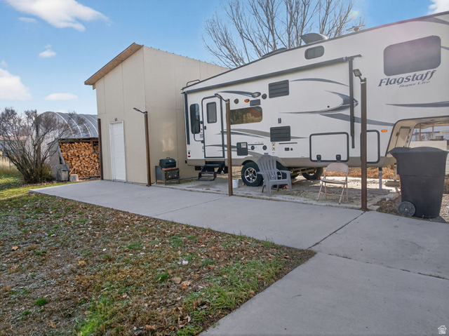 49 South 4th W Street Preston, ID 83263 - Photo 30 of 48 Concrete drive and patio area with a light-colored storage building