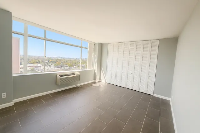 a view of an empty room with a window