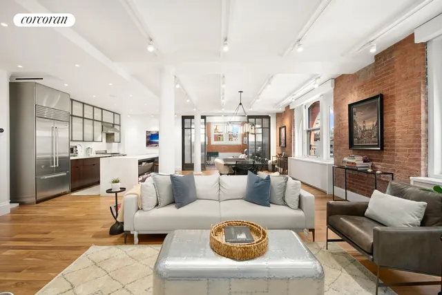 a living room with furniture and view of kitchen
