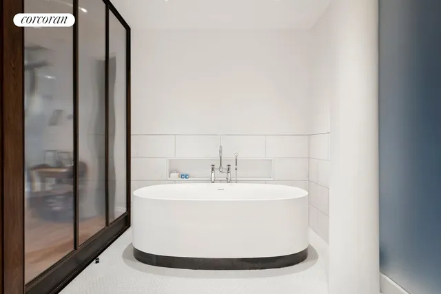 a white bath tub sitting in a bathroom