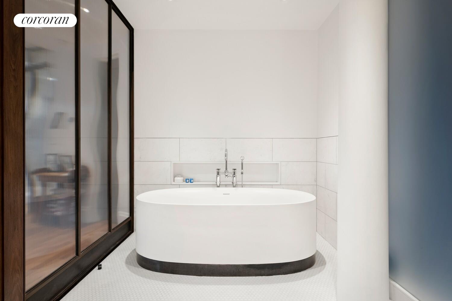 55 Hudson Street, Unit 7CD Manhattan, NY 10013 - Photo 16 of 25 a white bath tub sitting in a bathroom