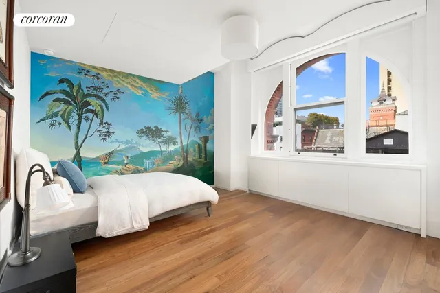 a living room with a bed furniture and a window