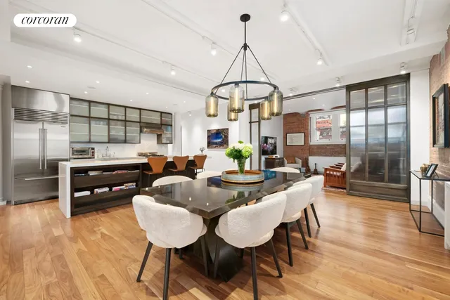 a living room with furniture a window and stainless steel appliances