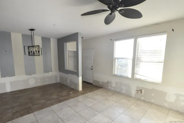 a kitchen with stainless steel appliances a sink a microwave a refrigerator and cabinets