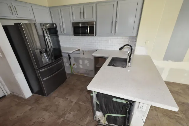 a kitchen with a sink and a microwave