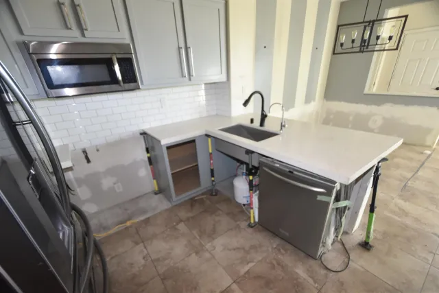 a view of an empty room with a cabinet and a window
