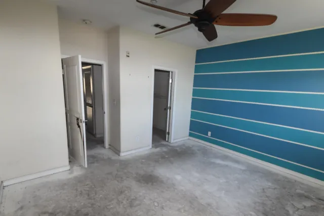 a bathroom with a granite countertop sink a toilet and shower