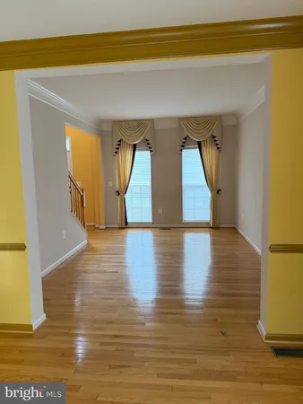 a view of room with window and wooden floor