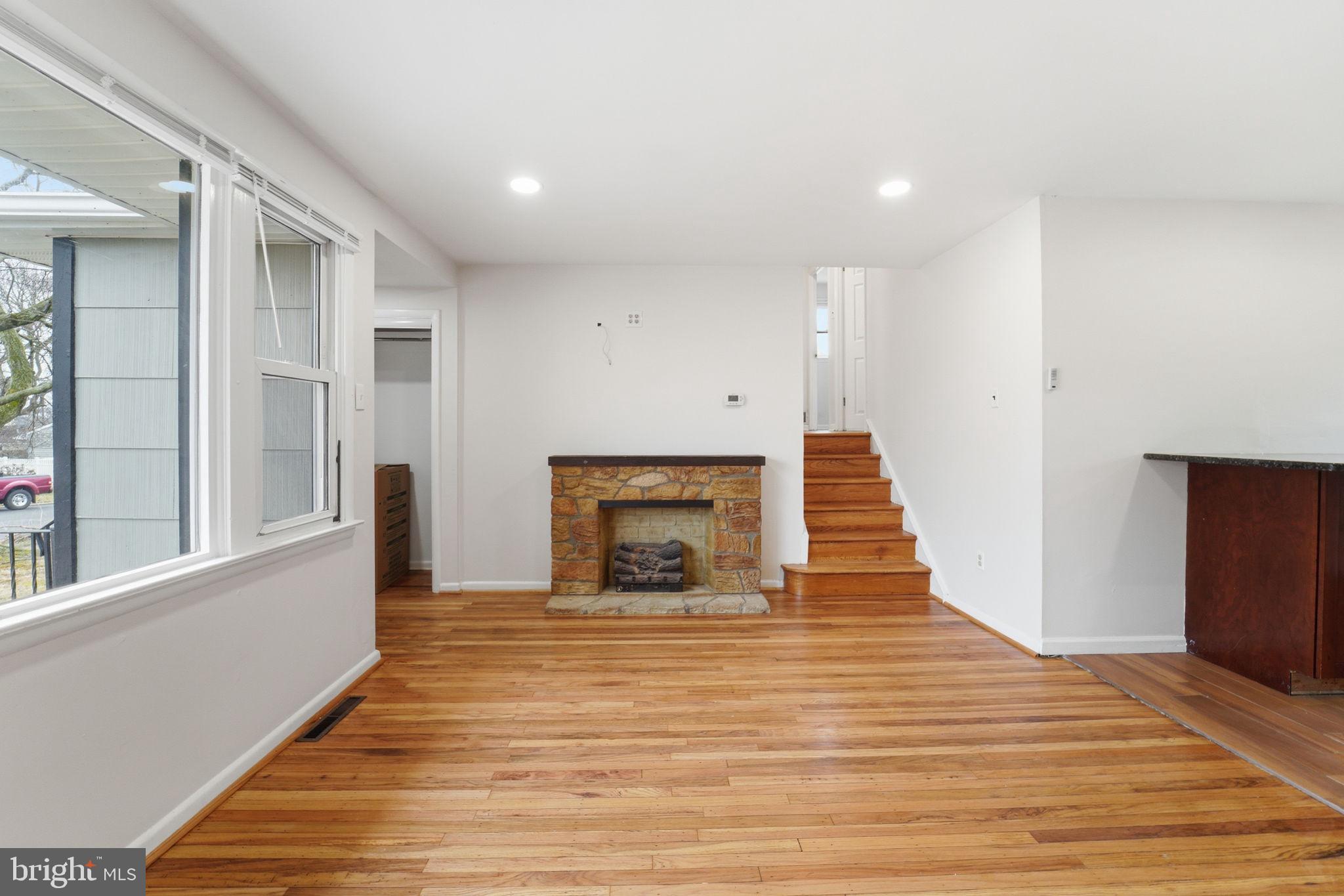 490 Hamilton Road Wenonah, NJ 08090 - Photo 15 of 49 a view of a livingroom with wooden floor and a fireplace