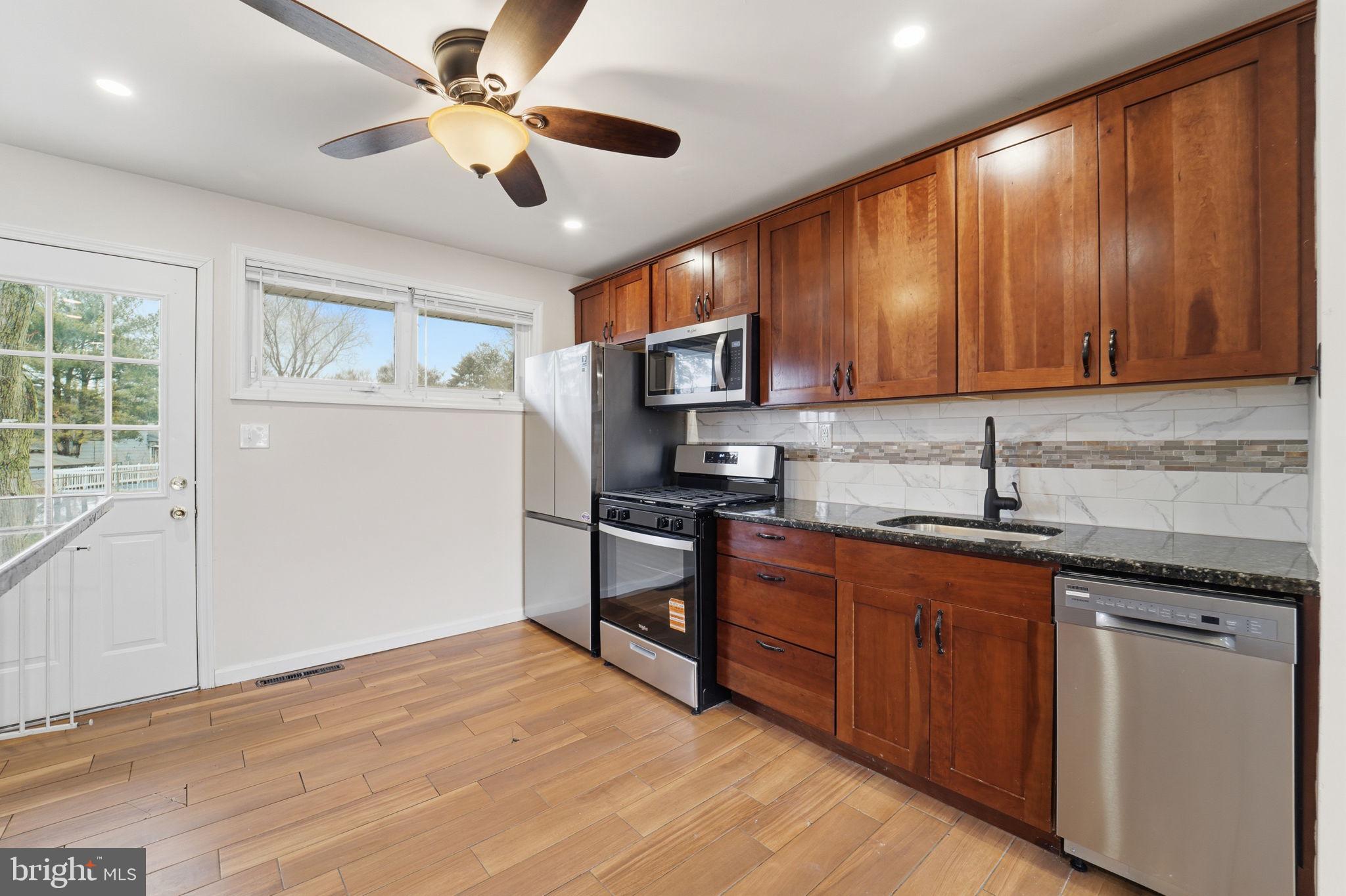 490 Hamilton Road Wenonah, NJ 08090 - Photo 20 of 49 a kitchen with stainless steel appliances granite countertop a stove sink and cabinets