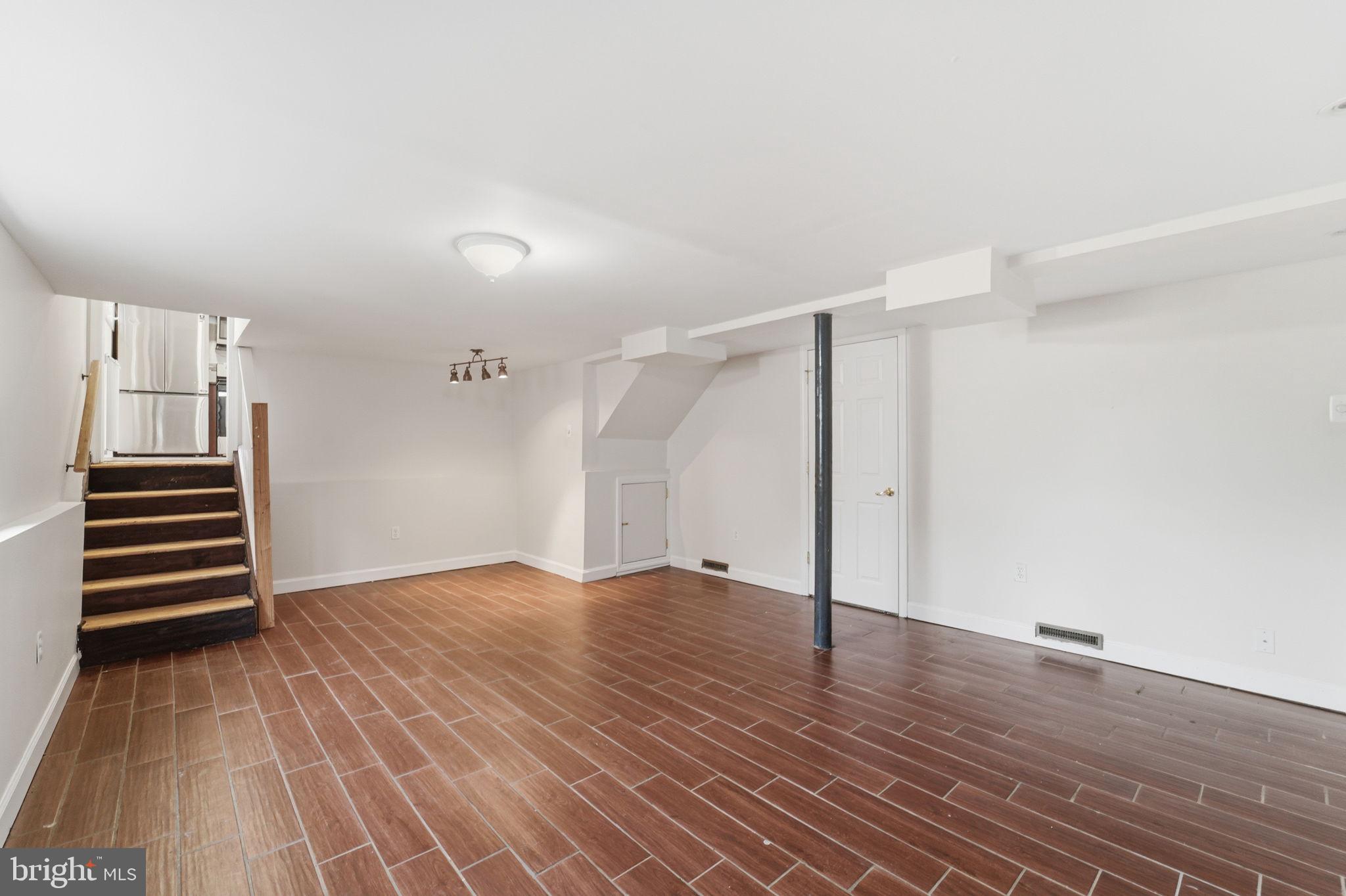 490 Hamilton Road Wenonah, NJ 08090 - Photo 22 of 49 an empty room with wooden floor and stairs