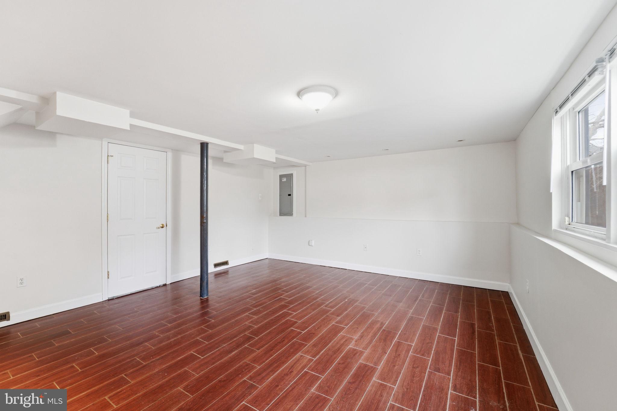 490 Hamilton Road Wenonah, NJ 08090 - Photo 24 of 49 a view of an empty room with wooden floor and a window