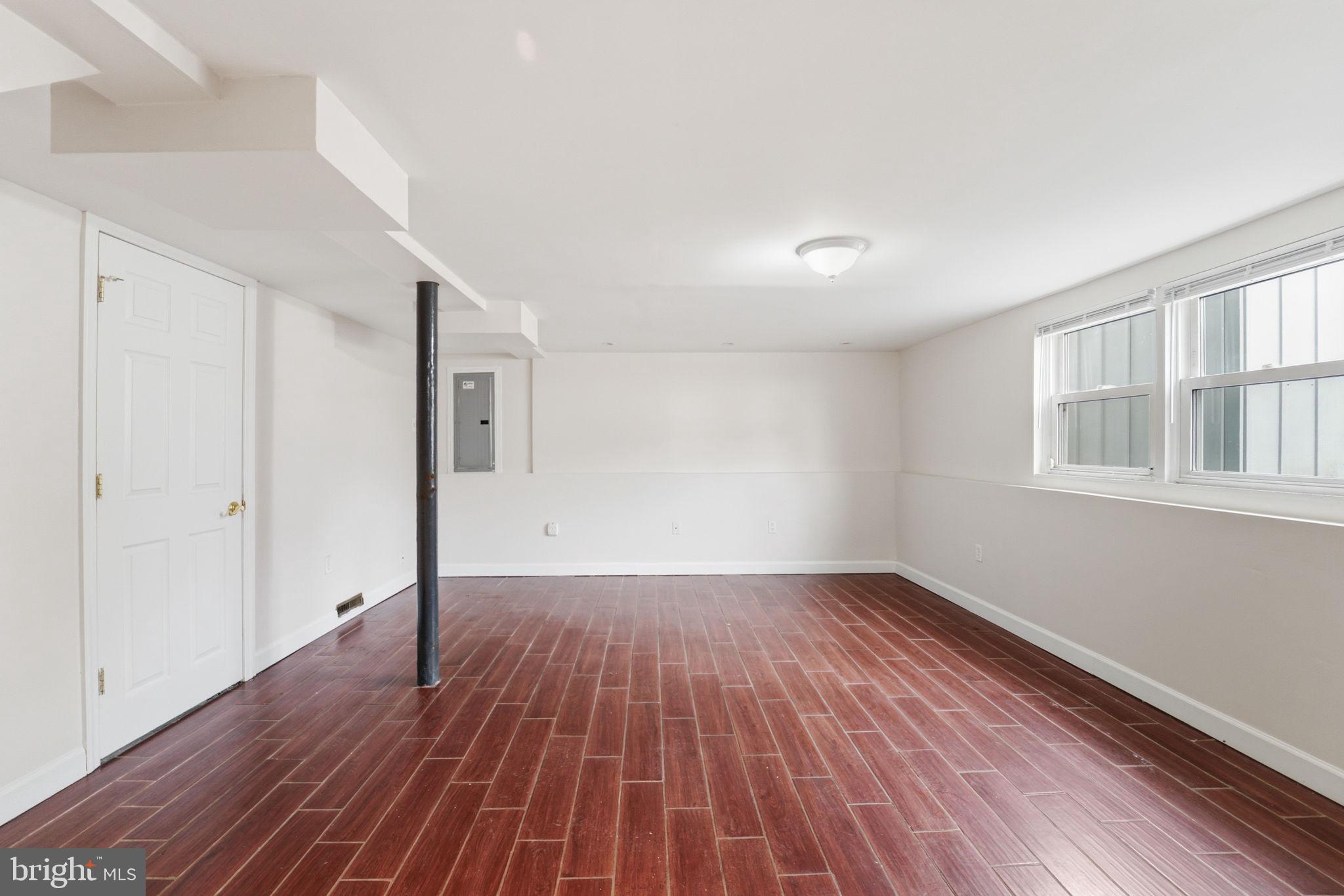 490 Hamilton Road Wenonah, NJ 08090 - Photo 28 of 49 a view of an empty room with wooden floor and a window