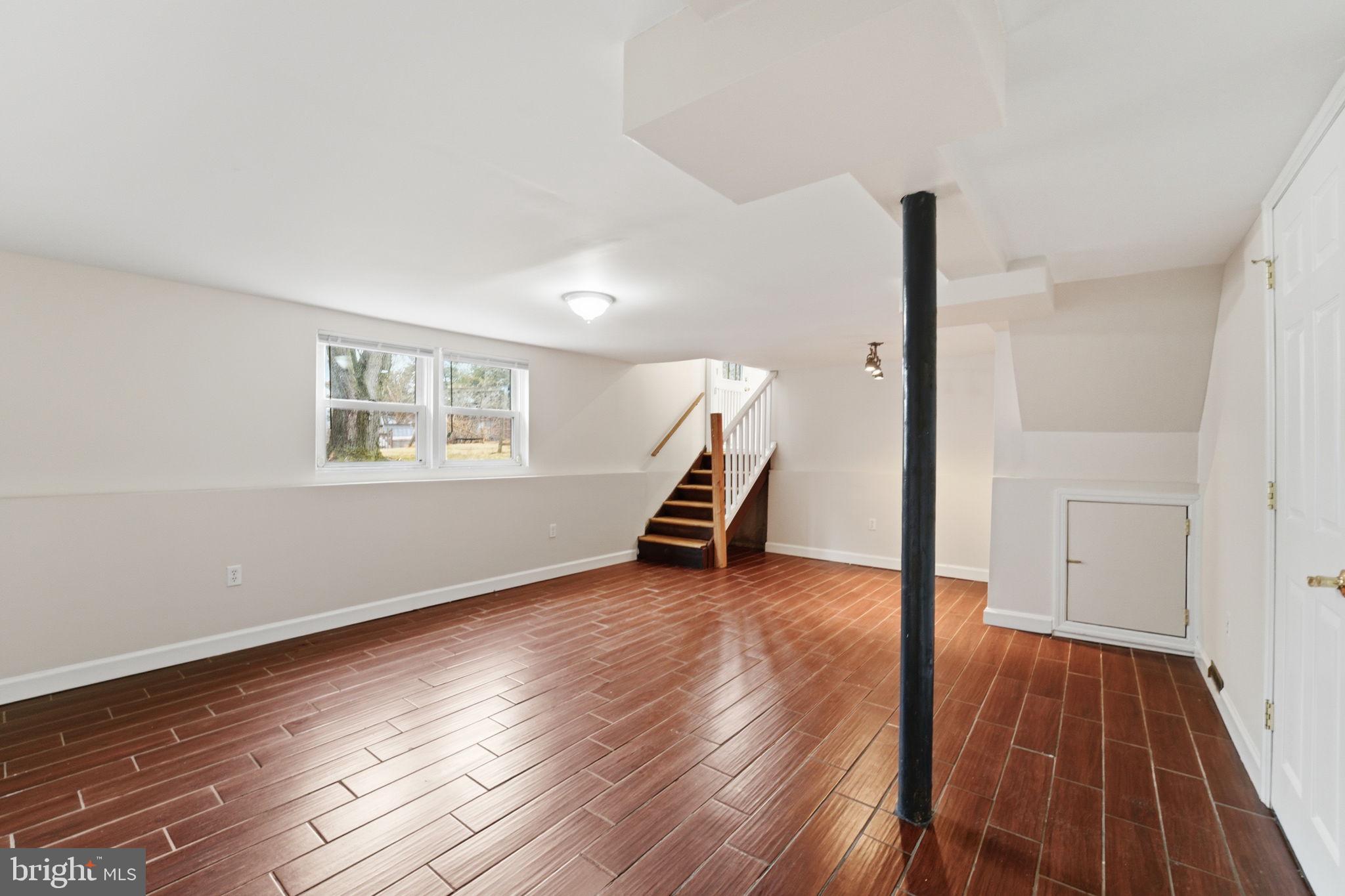 490 Hamilton Road Wenonah, NJ 08090 - Photo 29 of 49 a view of an empty room with wooden floor and a window