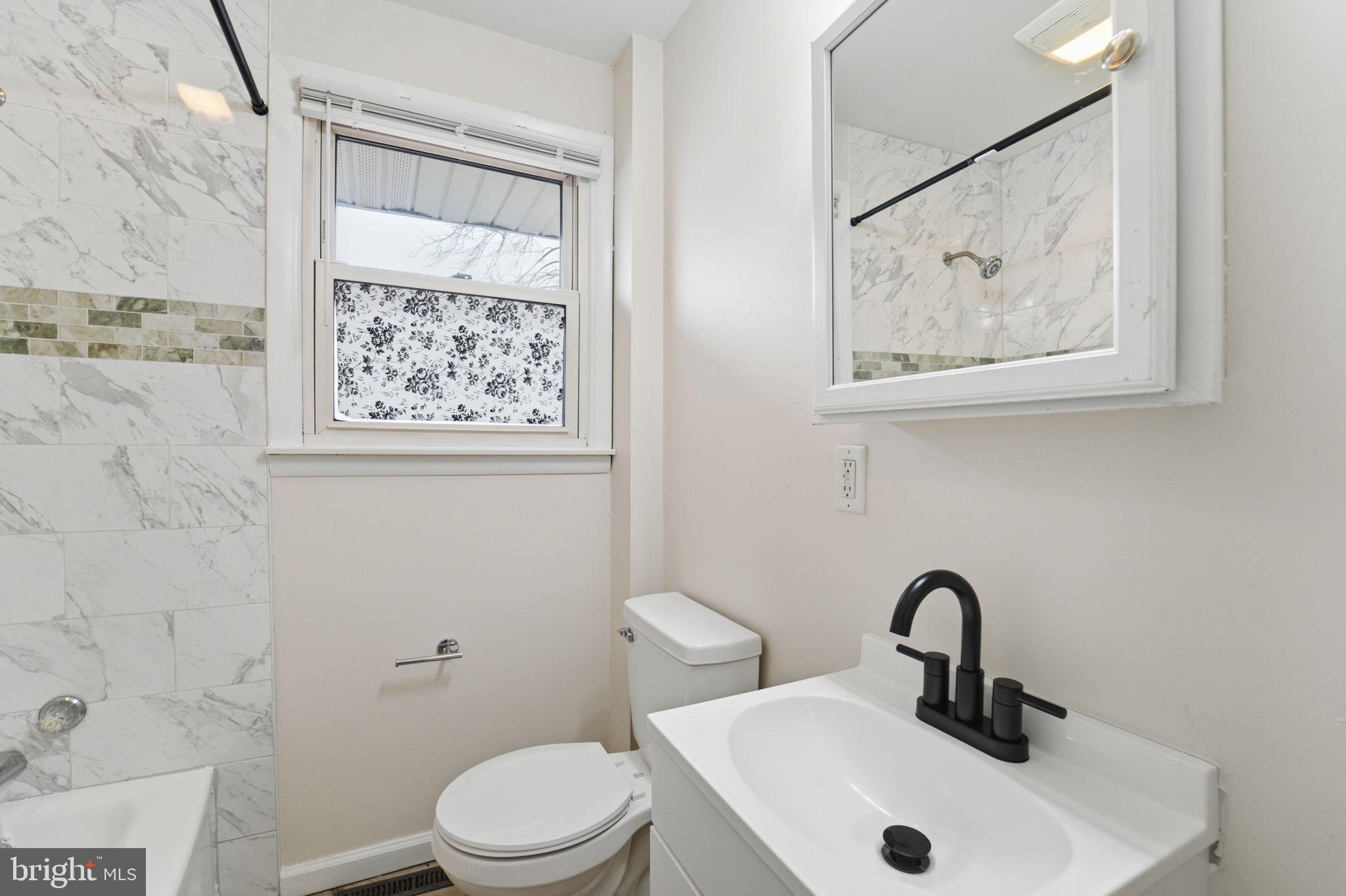 490 Hamilton Road Wenonah, NJ 08090 - Photo 30 of 49 a bathroom with a toilet sink and mirror